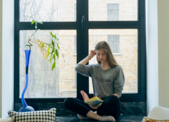a person sitting next to a window