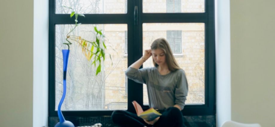 a person sitting next to a window